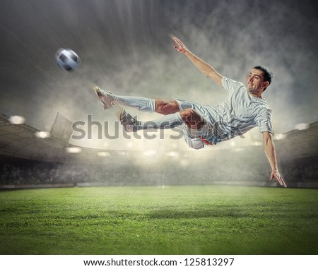 football player in white shirt striking the ball at the stadium under the rain