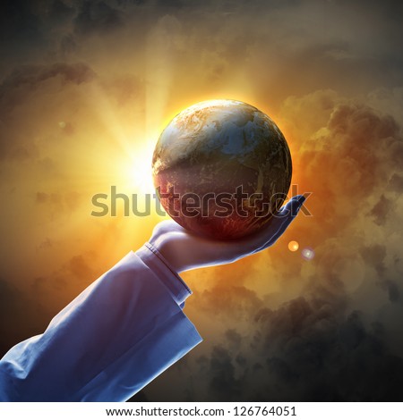 Hand of businessman holding earth planet against illustration background