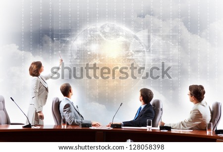 Image of businesspeople at presentation looking at virtual project.Elements of this image are furnished by NASA