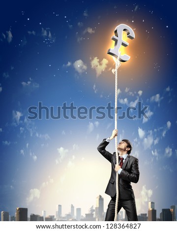 Image of businessman climbing rope attached to pound sign