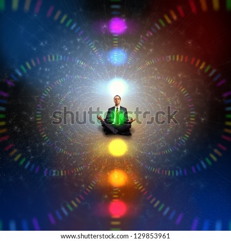 Businessman sitting in lotus flower position against zen background