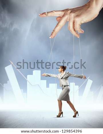 Businesswoman marionette on ropes controlled by puppeteer against bars background