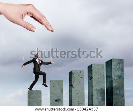 Businessman marionette on ropes controlled by puppeteer walking on bars