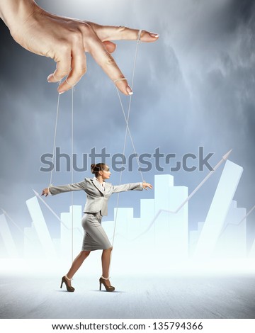 Businesswoman marionette on ropes controlled by puppeteer against bars background