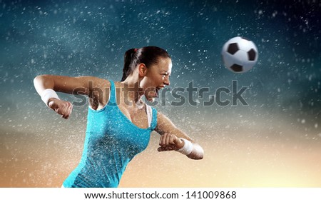 Image of young woman football player hitting ball