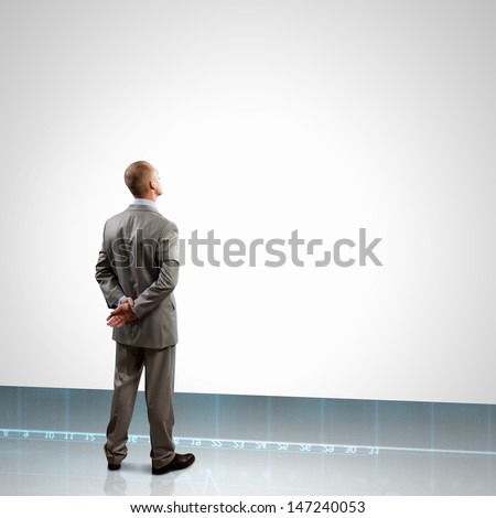 Back view image of businessman with arms crossed behind back. Place for text