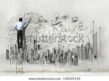 Back view of businessman drawing sketch on wall Back view of businessman drawing sketch on wall