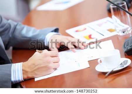 Image of businessman\'s hands signing documents at meeting