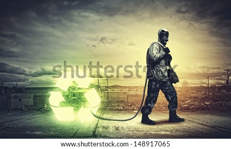 Man in respirator against catastrophe background. Recycle concept