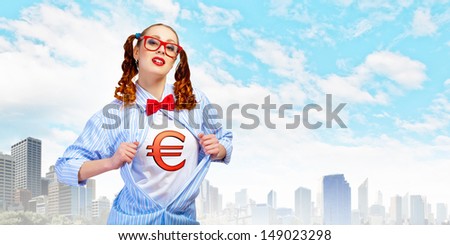 Young woman acting like super hero with euro sign on chest