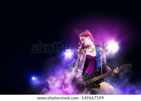 Young Attractive Rock Girl Playing The Electric Guitar