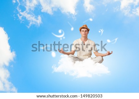 Young handsome man meditating sitting on clouds