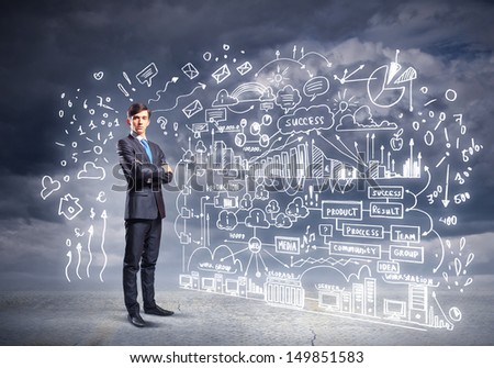 Image of young businessman standing against business sketch