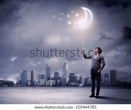 Young man and the moon symbol against polluted and ruined landscape