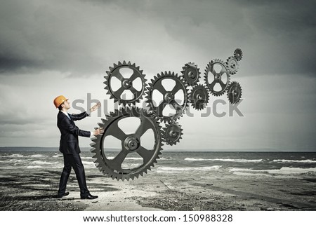 Businessman with cog wheel elements. Construction concept