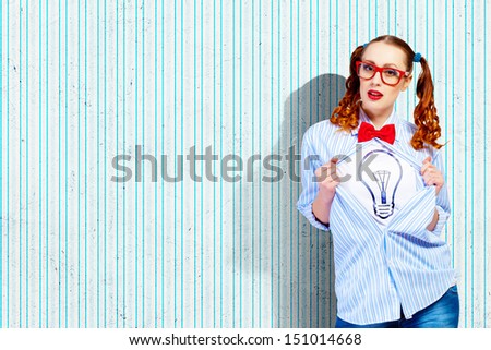 Young woman acting like super hero with bulb illustration on chest
