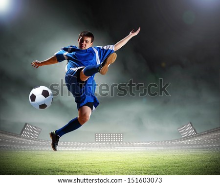 Image of football player at stadium hitting ball Image of football player at stadium hitting ball