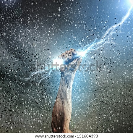 Close-Up Of Human Hand Clenching Lightning Flash