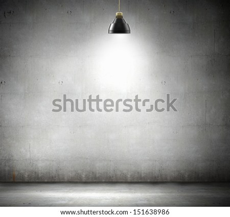 Stone blank wall illuminated with hanging above lamp. Place for text