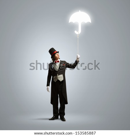 Image of wizard in hat holding umbrella