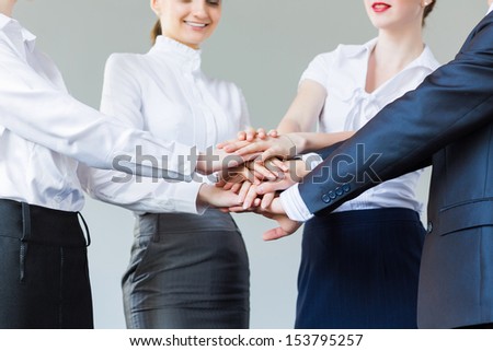 Business people making pile of hands. Partnership concept