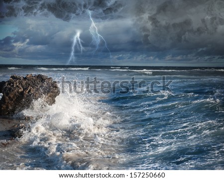 Image of dark night with lightning above stormy sea