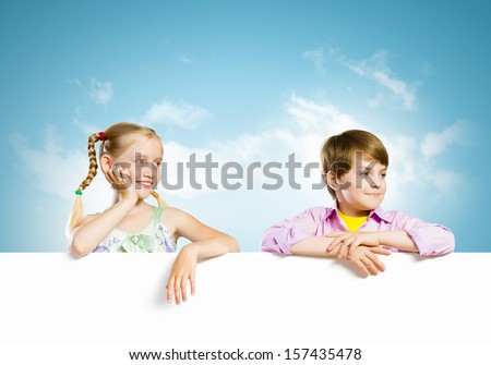 Image of cute kids holding blank white banner. Place for text