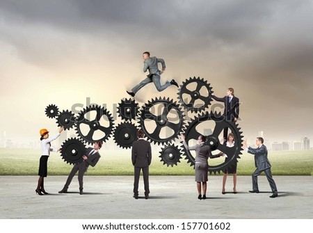Conceptual image of businessteam working cohesively. Interaction and unity