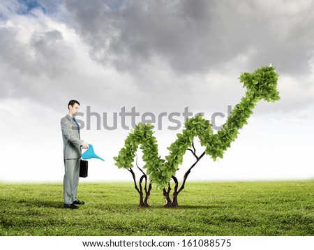 Image of businessman watering plant shaped like arrow