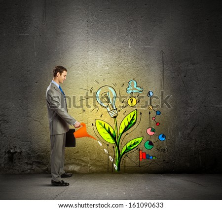 Image Of Businessman Watering Sprout With Can