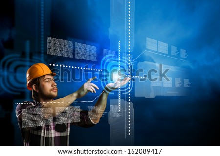 Image of man builder touching icon of media screen