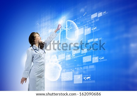 Image of young woman doctor touching icon of media screen