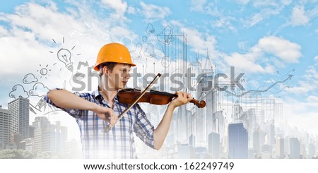 Image of man builder playing on violin