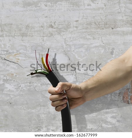 Cable in human hand. Power and connection