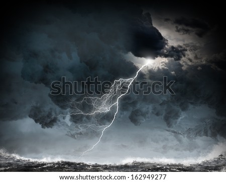 Image of dark night with lightning above stormy sea