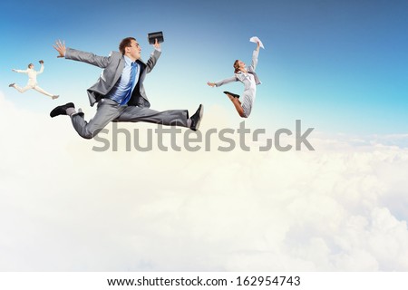 Image of happy business people jumping high in sky