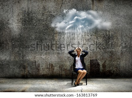 Image of young troubled businesswoman standing under rain