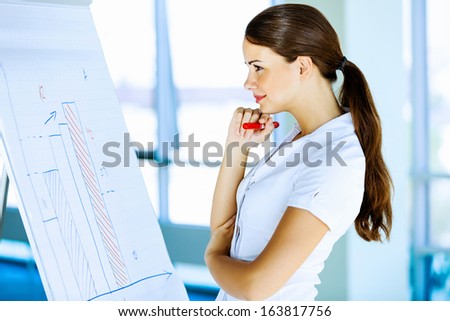 Image of young attractive businesswoman with arms crossed on chest