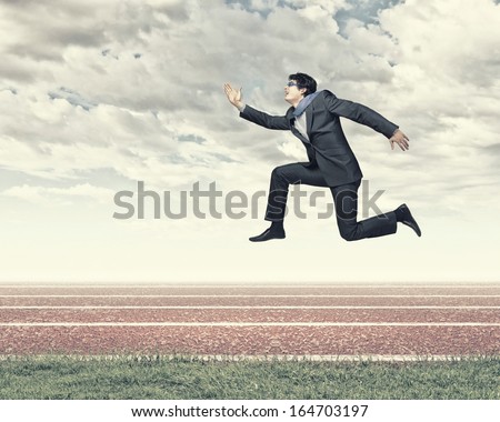 Funny image of running businessman at stadium. Competition concept