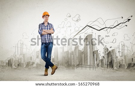 Image of man builder with arms crossed on chest against urban scene