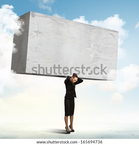 Image of businesswoman holding stone on her shoulders