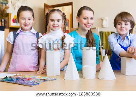 Little children painting and playing at kindergarten