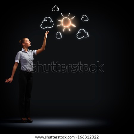 Image of attractive businesswoman against dark background with sun