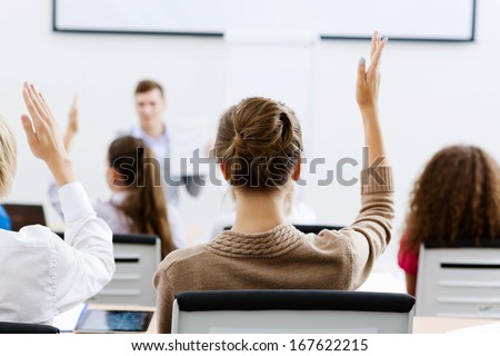 Young Teacher In Classroom Standing In Front Of Class