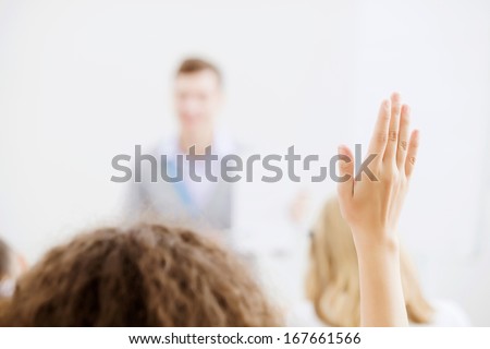 Young Teacher In Classroom Standing In Front Of Class