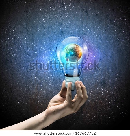 Image of human hand holding bulb with earth planet inside Elements of this image are furnished by NASA Image of human hand holding bulb with earth planet inside Elements of this image are furnished by NASA