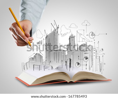 Opened book and hand drawing building sketches