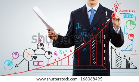 Close up of businessman with documents in hand drawing business sketches
