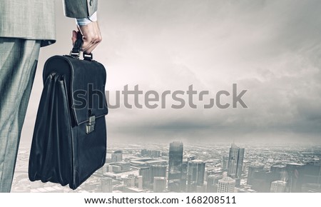 Back View Of Businessman With Suitcase Looking At City