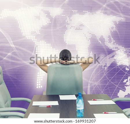 Businesswoman boss in conference room sitting with back in chair